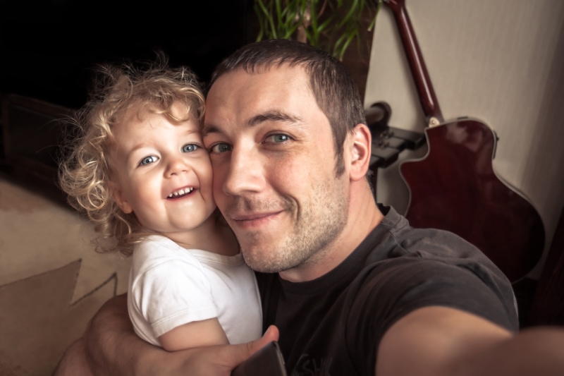 Father taking selfie with daughter, not worrying about his home's indoor air quality. Scott Brothers blog image.