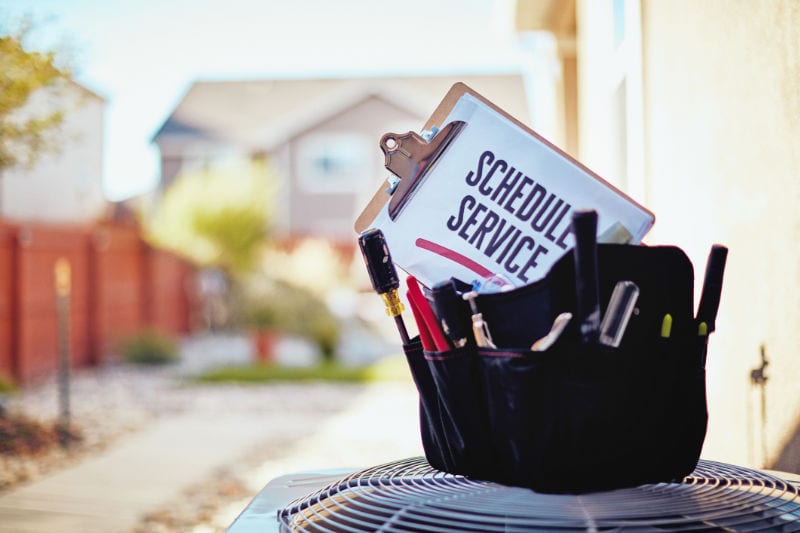 Technician bag with schedule service sign. Scott Brothers Heating & Air blog image.